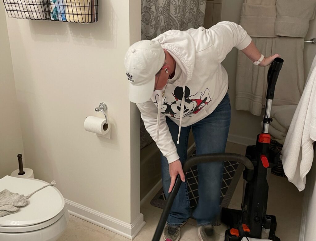 Professional cleaner sanitizing a kitchen counter in Holmdel, NJ