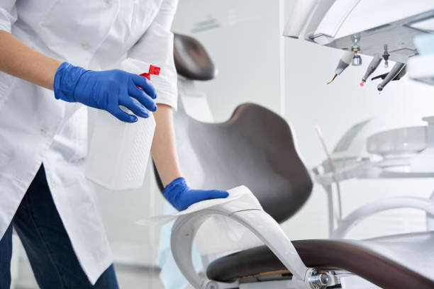 Dental Office Cleaning staff disinfecting treatment room surfaces inside an Asbury Park, NJ practice before opening