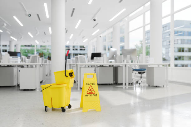 Office cleaning worker vacuuming a conference room in Lavallette, NJ before morning appointments