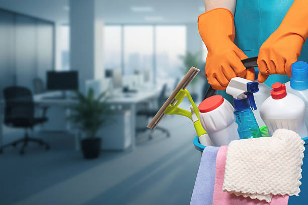 Office cleaning specialist disinfecting shared workstations in a Pt. Pleasant, NJ business suite
